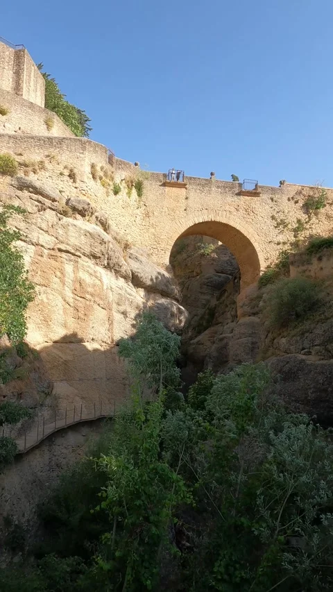 Vertical video of an old stone bridge and medieval walls in Ronda Stock Footage 344577807