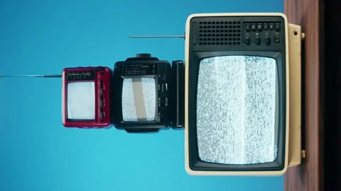 Vertical video of old televisions with grey interference screen on blue Stock Footage 169734098