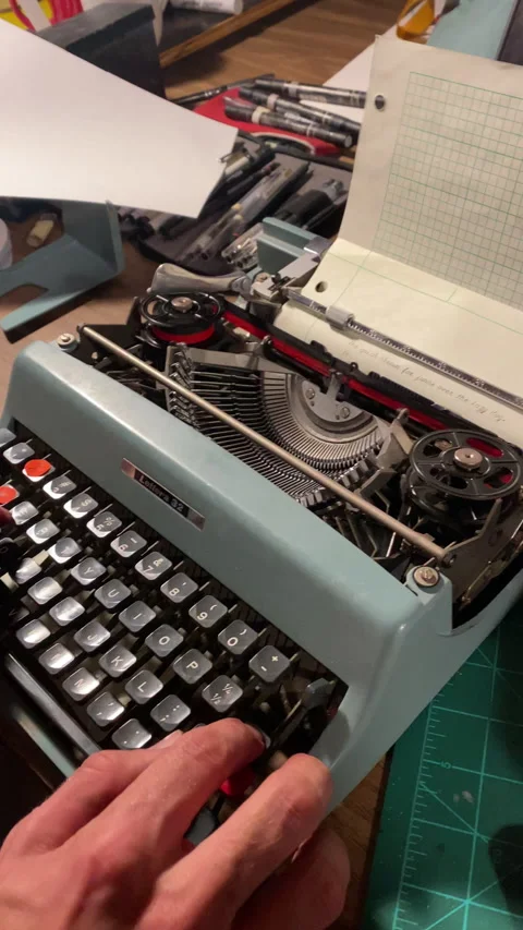 Vertical video of old type writer testing typing Stock Footage 223435624