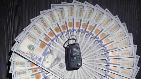 Vertical video. One hundred dollar bills rotates with a car key. Video stock 262521409