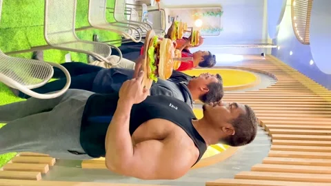 Vertical video A one-kilogram burger eating competition Stock Footage 232288296