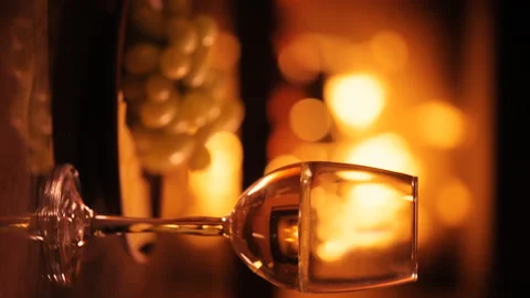Vertical video of one white wine wineglasses over fireplace background. Stock Footage 98926444