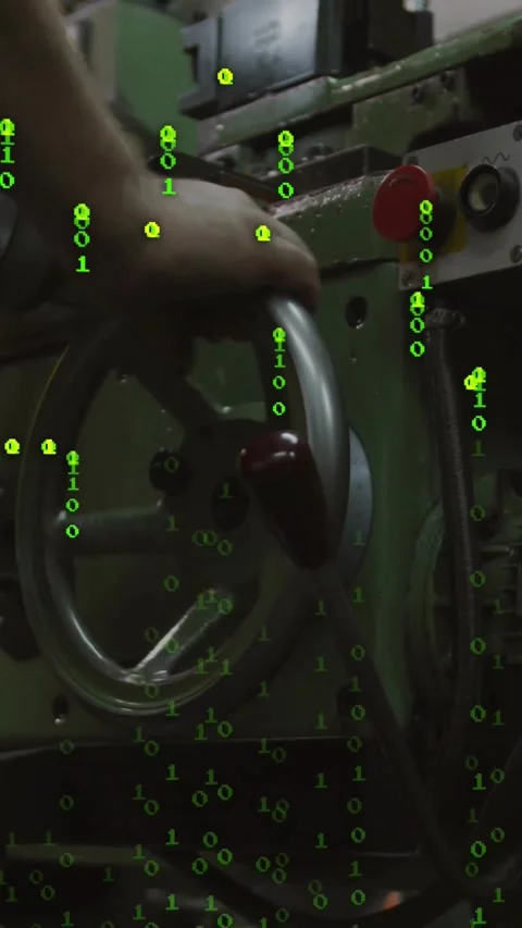 Vertical video: Operator gripping wheel, turning to adjust lathe as green code Video stock 330605333