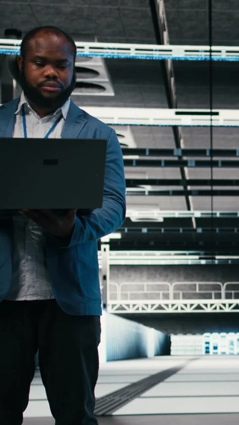 Vertical video Optimizing electronics, laptop and team of software developers in Stock Footage 330028562