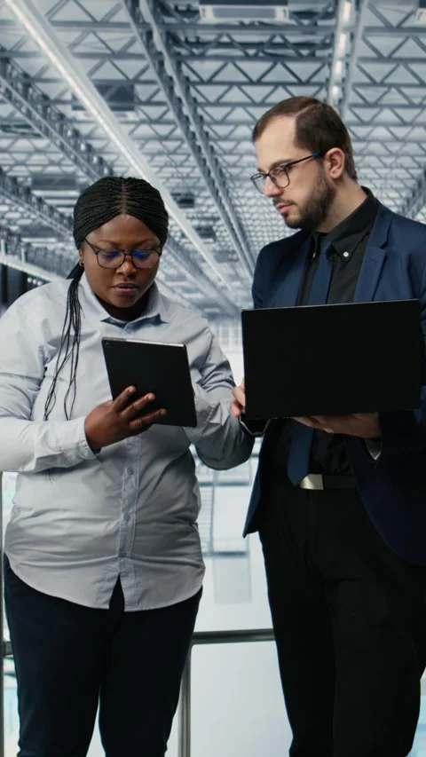 Vertical video Optimizing workflow, microchips and woman with coworker using EDA Stock Footage 333614103