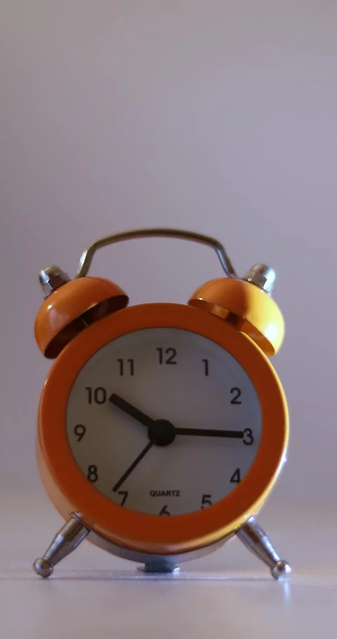 Vertical video of a orange vintage clock time passing over a day to night on  Stock Footage 300364704