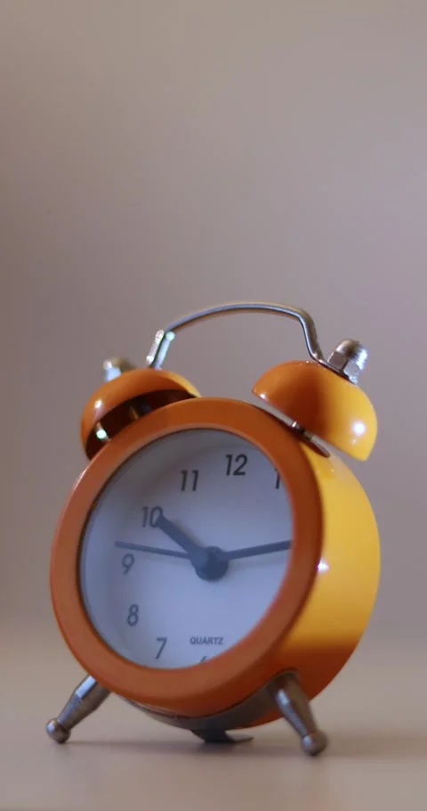Vertical video of a orange vintage clock time passing over a day to night on  Stock Footage 300364705