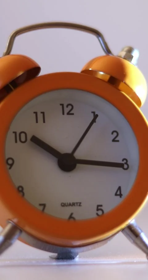 Vertical video of a orange vintage clock time passing over a day to night on 库存影片 301393694