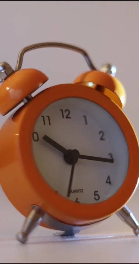 Vertical video of a orange vintage clock time passing over a day to night on Stock Footage 301393718