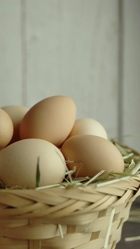 Vertical video of Organic eggs on Woven basket Close up Stock Footage 280628188