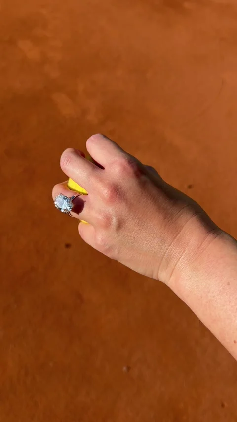 Vertical video oval diamond ring holding tennis ball on court Stock Footage 319166044