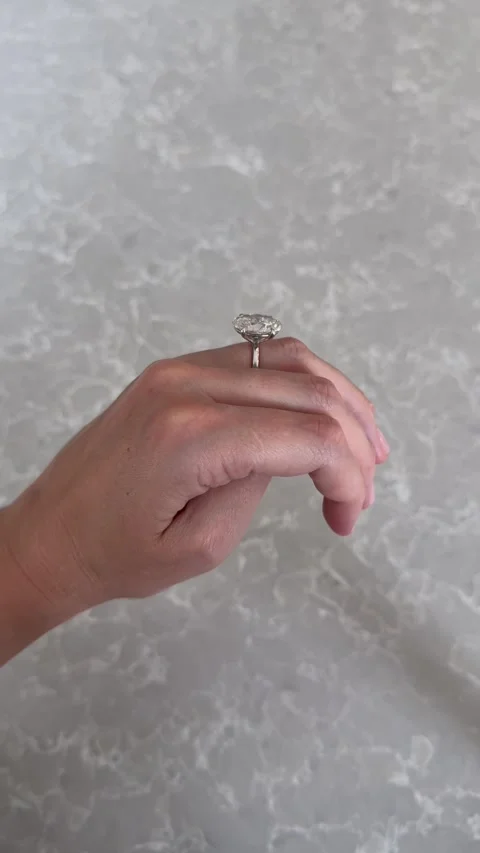 Vertical video of oval diamond wedding band against gray marble background 스톡 동영상 316813243