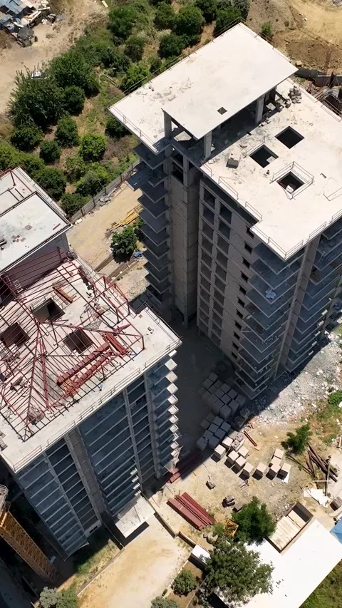 Vertical Video: Overhead View of a Large Building Project with Cranes and Active Stock Footage 297717757