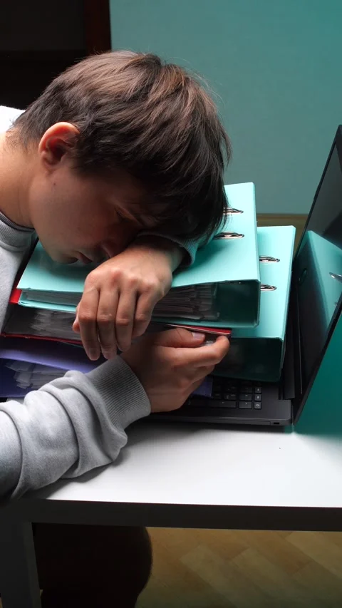 Vertical video overworked man sleeping with his head resting on a stack of Stock-Footage 346250546