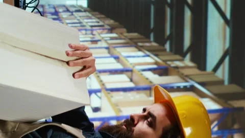 Vertical Video Packaging engineer uses barcode scanner to verify each item Stock Footage 257969017