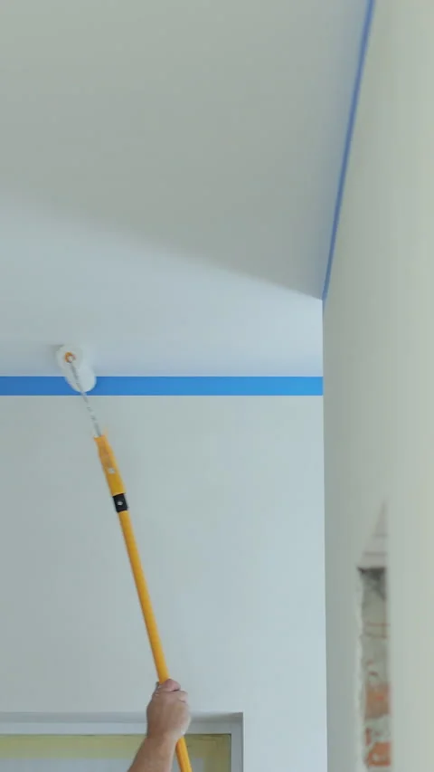Vertical video Painting the ceiling white with the brush, repairing Stock Footage 339060484