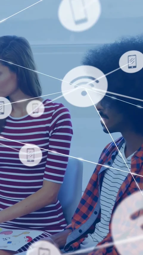 Vertical video: Pair sitting in meeting, on cue WiFi nodes covering faces and Stock Footage 334602691