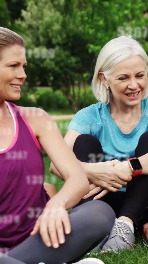 Vertical video: Pair touching after woman checking red smartwatch, fitness data Stock Footage 332846516