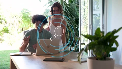 Vertical video: Pair working at laptop, magnifier appearing over laptop Vídeo Stock 333132515