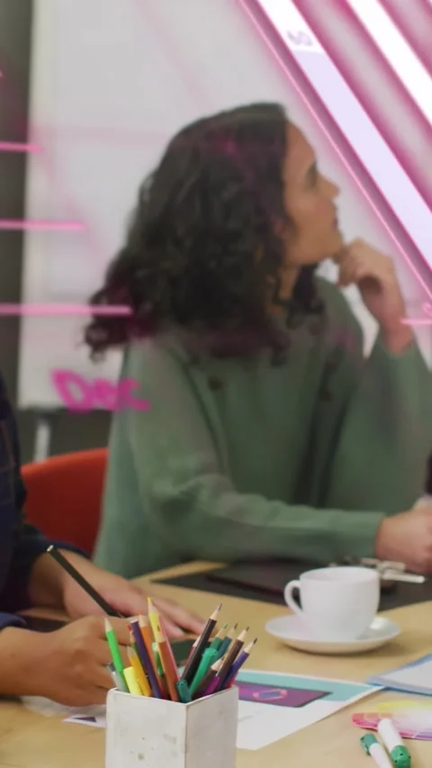Vertical video: Pair writing turning to speaker pink overlay showing charts over Vídeo Stock 334599123