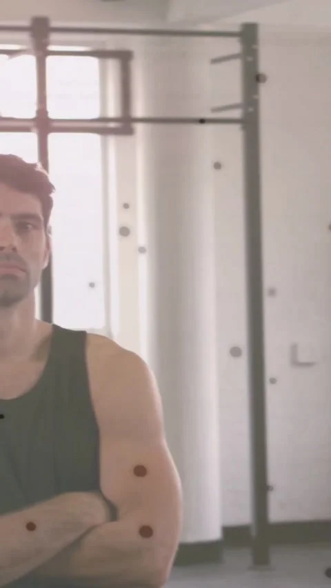 Vertical video: Pan moving revealing male stepping in gym crossing arms, code Stock Footage 334602627
