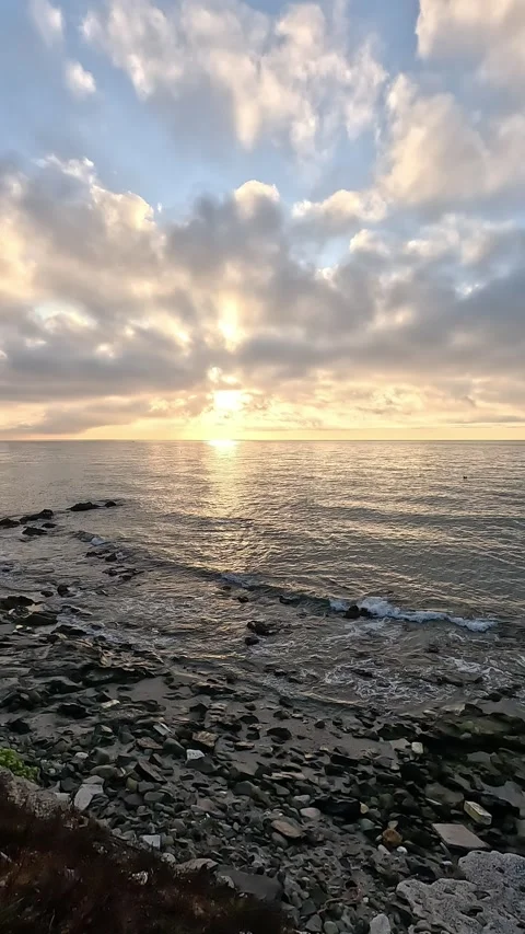 Vertical video of a panoramic over the sea at sunrise Stock Footage 342494586
