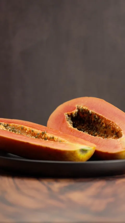 Vertical video, Papaya cut in half showing its interior Stock Footage 328896642