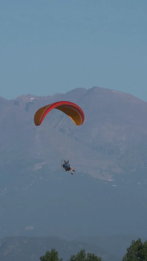 Vertical Video Paraglider Soars with High Mountain Peaks Stock Footage 231581595