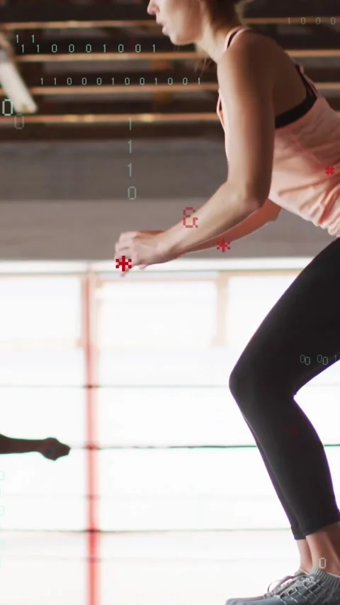 Vertical video: Partner holding line cueing female doing squat jumps, code Stock Footage 334602813
