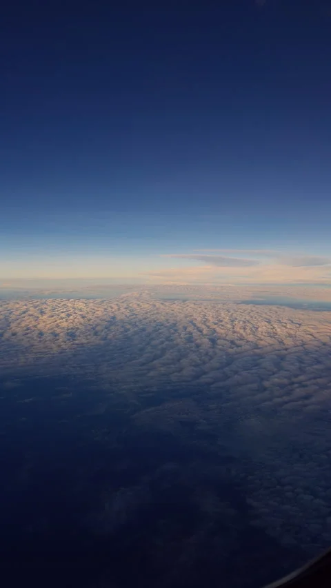 Vertical video. Passenger Airplane Wing Above Calm Ocean And Cloudy Horizon Duri Stock Footage 337151236