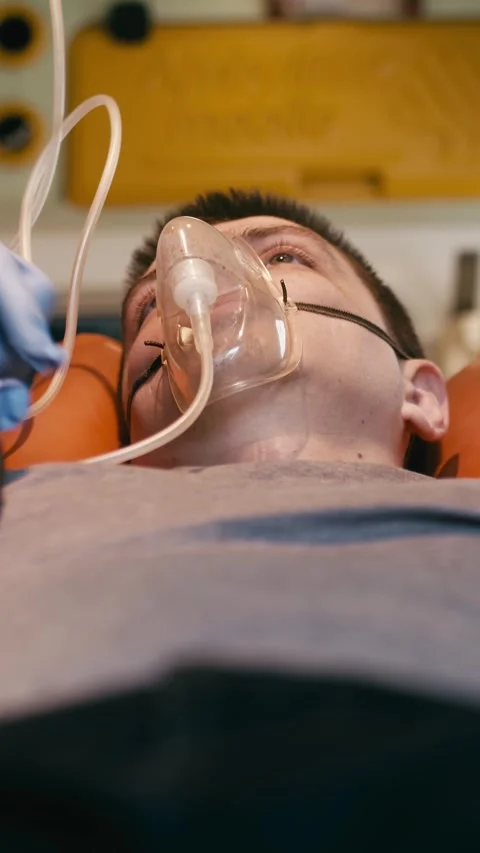 Vertical video. Patent, paramedic and blood pressure with oxygen mask Stock Footage 285148759