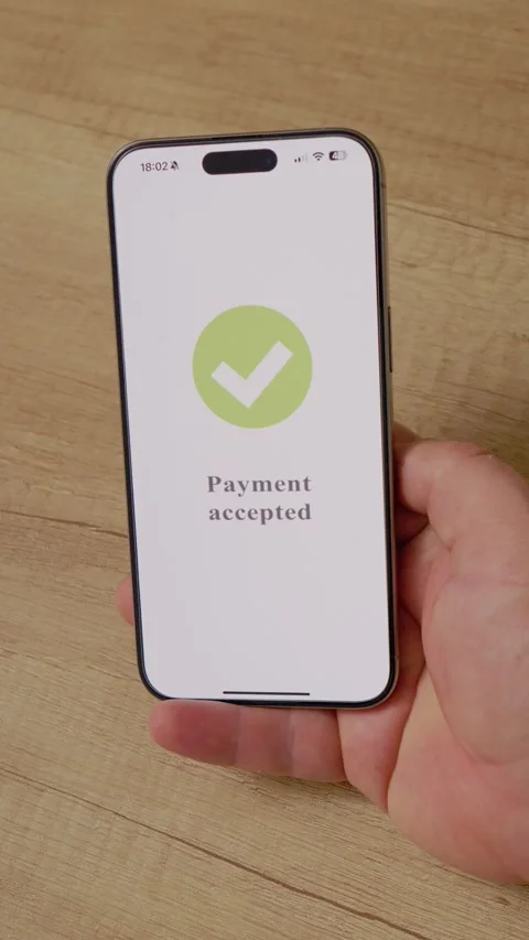 Vertical video Payment accepted message on smartphone screen in man's hand Stock Footage 346716313
