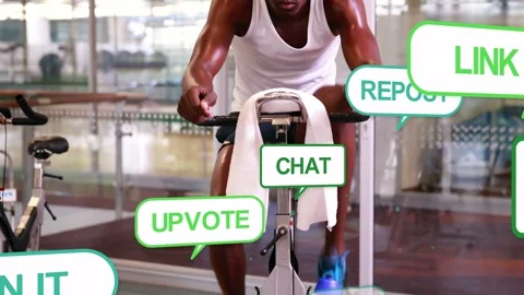 Vertical video: Pedaling man in white tank training on gym bike, with towel 스톡 동영상 333233507