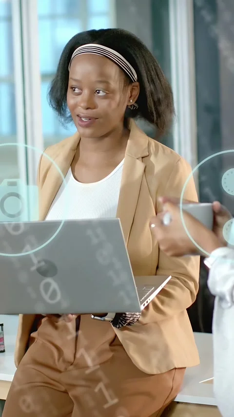 Vertical video: Peer smiling sparking binary icons as woman on desk using laptop Stock Footage 335802649