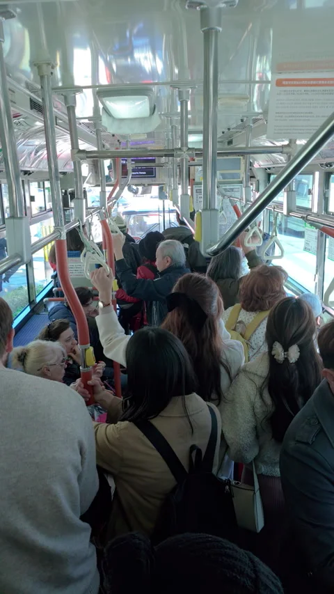 Vertical video of people inside a crowded bus in Japan Stock Footage 272438704