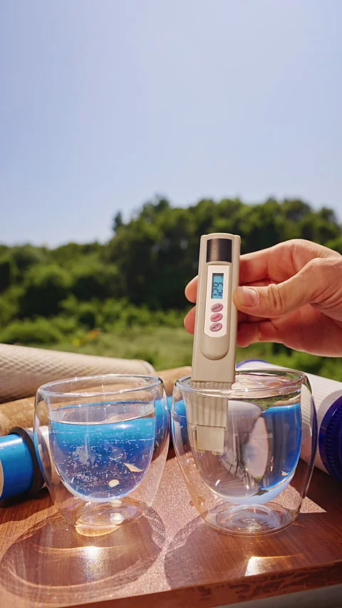 Vertical video. Person Measuring Total Dissolved Solids in Water With a Digital Stock Footage 339204917