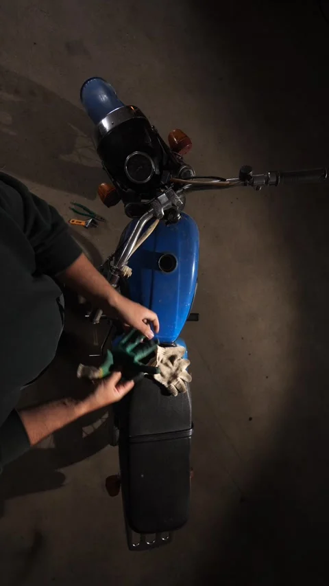 Vertical video Person removing work gloves after completing maintenance or Stock Footage 342764321