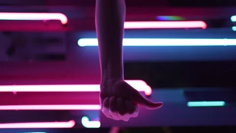 Vertical video - person shows a like in the light of neon lamps. Success and Stock Footage 145437168