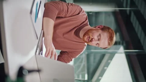 Vertical Video, Personal Branding, Work. Man Focused at Computer in Office Stock Footage 311545410