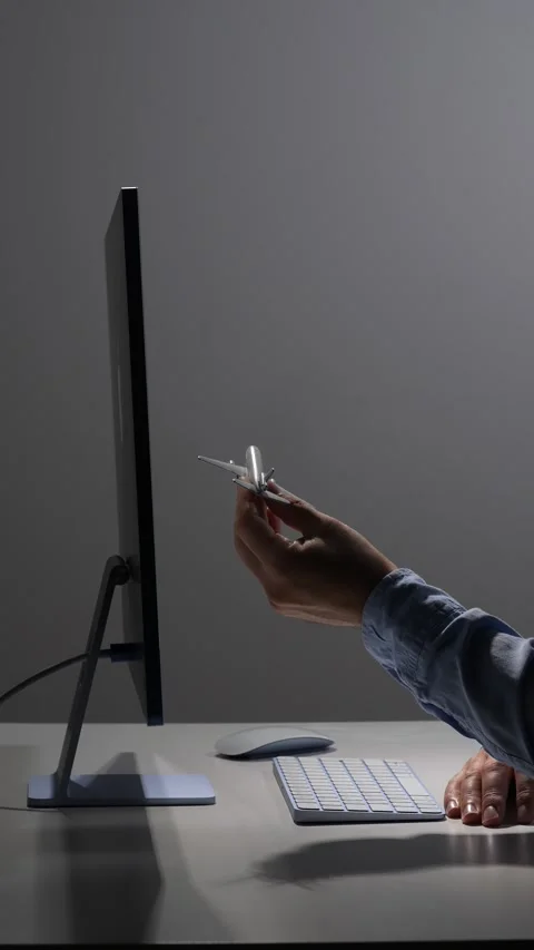 Vertical video person's hand holding a miniature airplane model, visualizing Stock Footage 342673485
