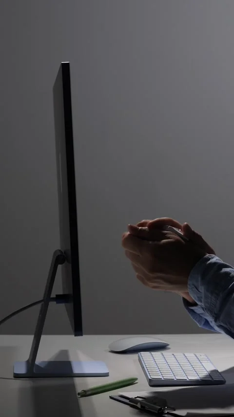 Vertical video person's hands holding crumpled paper near a computer screen and Stock Footage 342671508
