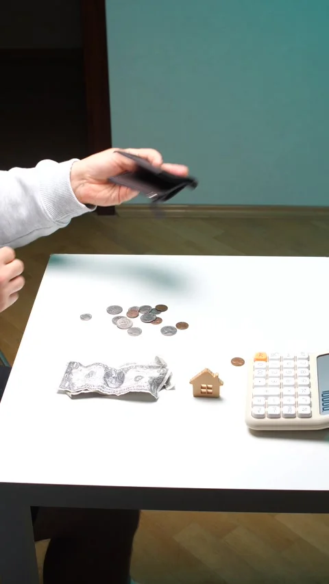 Vertical video person's hands holding an empty wallet over a table with Stock Footage 345170048