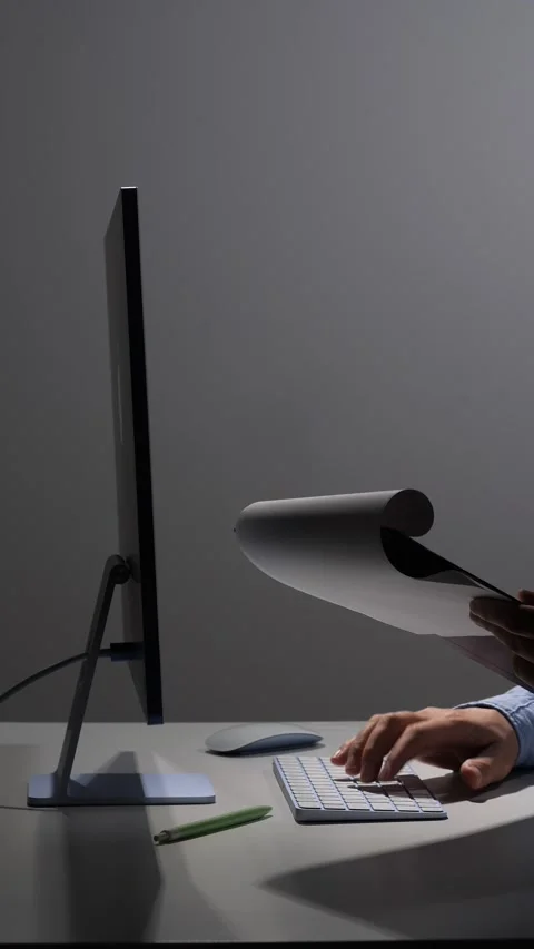 Vertical video person's hands working at a desk on a computer keyboard with a Stock Footage 342672355