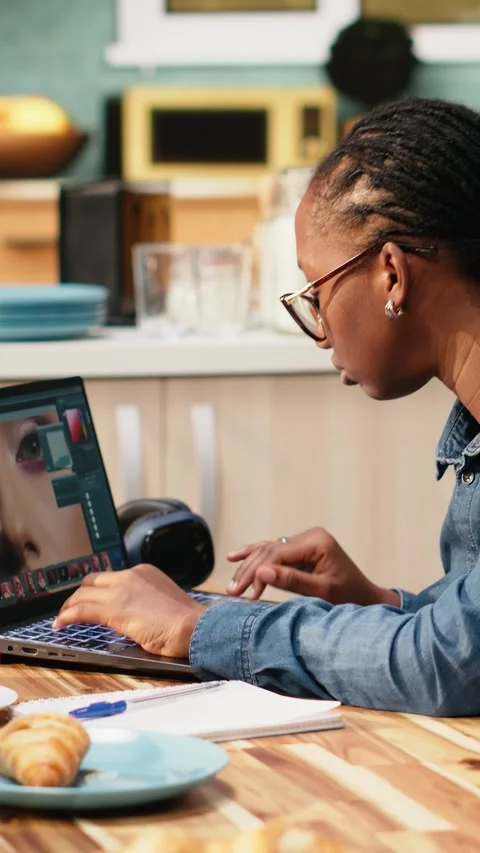 Vertical Video Photo editor designer retouching on laptop doing image selection Stock Footage 344530948