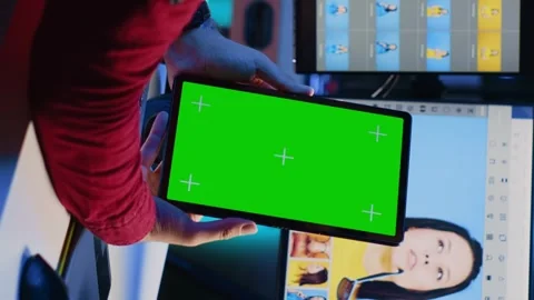 Vertical video Photo editor learning from tutorial on green screen tablet while Stock Footage 258801410
