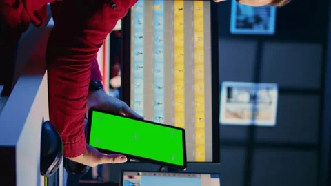 Vertical video Photographer watches tutorial on mockup tablet to learn how to Stock Footage 258074852