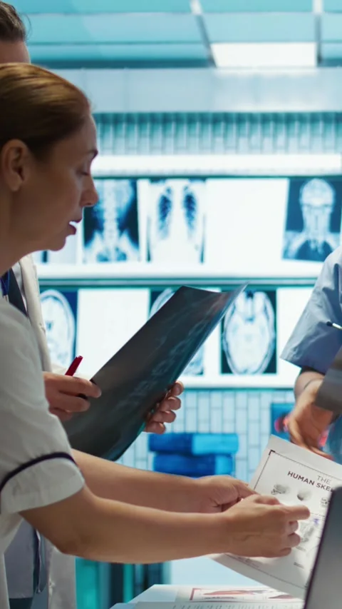 Vertical Video Physicians and radiologists analyzing x ray scans to create Stock Footage 282485229