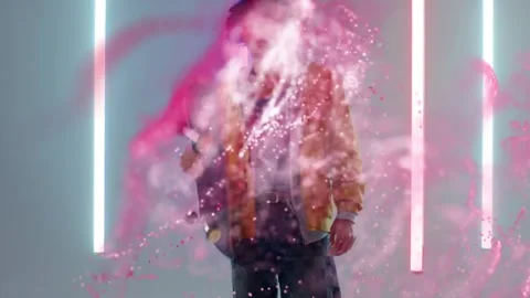 Vertical video: Pink particles driving yellow jacket skater stepping off deck Stock Footage 334179356