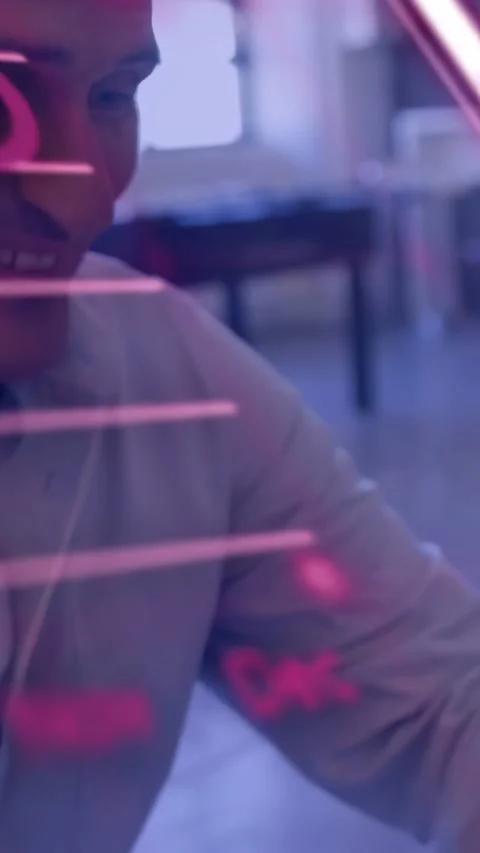 Vertical video: Pink text appearing, man at desk, finance bar chart overlay Stock Footage 334599042