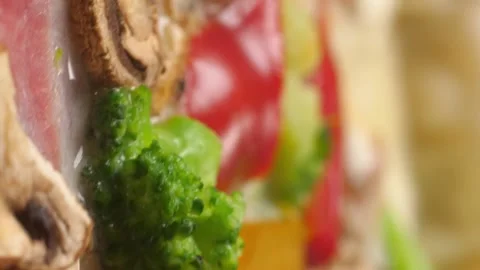 Vertical video. Pizza close up spinning in front of the camera. Video stock 209658983